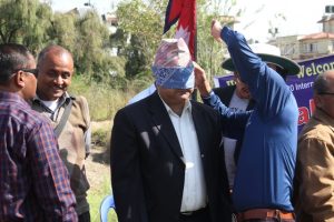 Sports Secretary of Nepal Government Dipendra Sharma with blind fold in his eyes ready to play cricket.